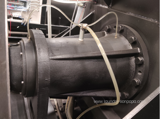 Close-up of a laundry machine component and tubing